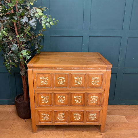 Vintage warm wooden dowry chest with three tiers of nine square panels and delicate white floral inlays