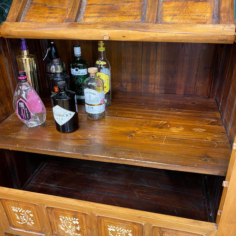 A vintage dowry chest with warm polished wood and decorative floral inlays perfect as a sideboard or cocktail cabinet
