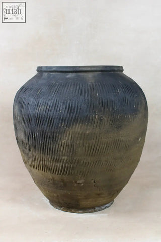 Vintage textured grey ceramic jar with horizontal ridges and earthy patina perfect for rustic decor
