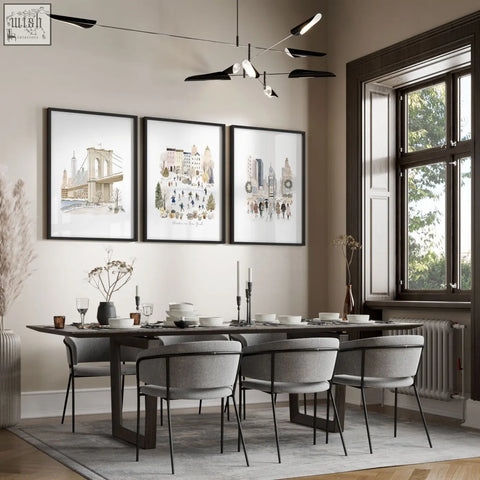 Three vintage travel art prints of winter in new york cityscape in beige tones hang above a dining room table