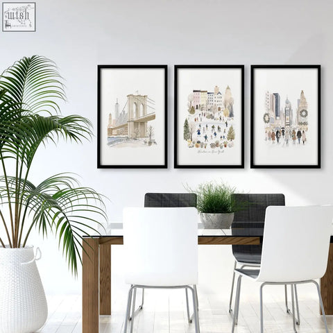 Three black-framed vintage travel art prints winter in new york watercolor cityscape hang above a dining room table