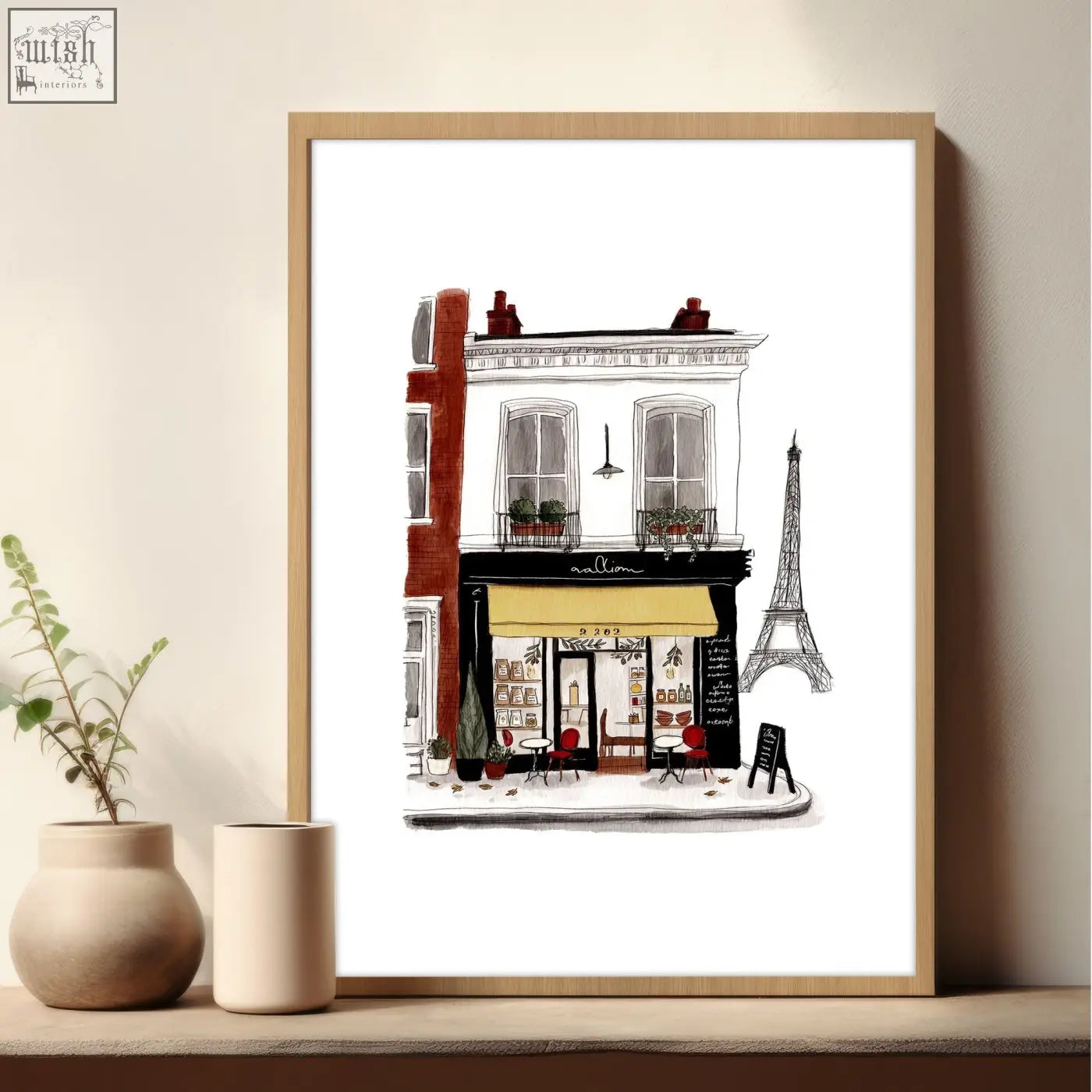 Framed vintage travel wall art print of a parisian café with black white details red facade and yellow awning
