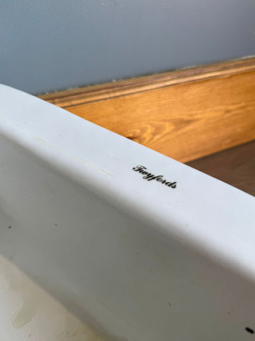 White ceramic vintage twyfords bathtub with subtle black cursive logo on rim perfect for classic bath setups