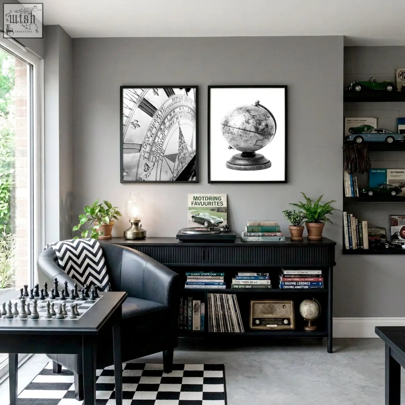 Black leather armchair with bold black and white chevron pillow next to vintage world map canvas for games room decor