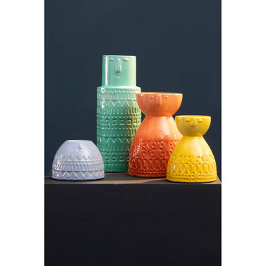 A collection of colorful ceramic vases including the visage small yellow face vase with embossed patterns
