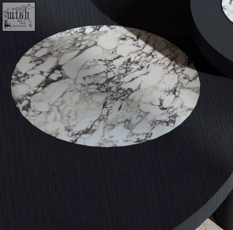 Vivien coffee table set features a circular white marble-patterned placemat with black veining on a wood coffee table