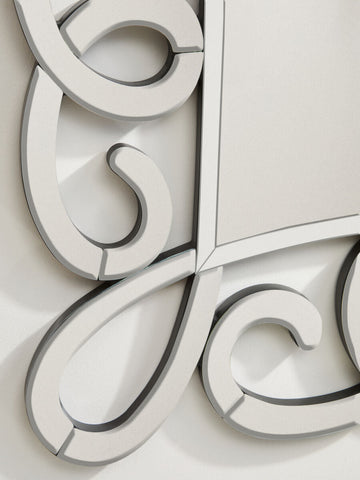 Vivienne black and silver scroll design wall mirror with a sleek silver scroll design frame and flowing interlocking curves