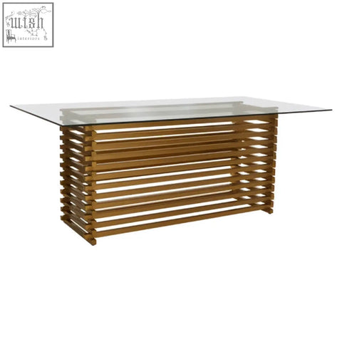 Modern rectangular dining table with clear glass top and wooden slat base in warm finish for matte gold dining table style