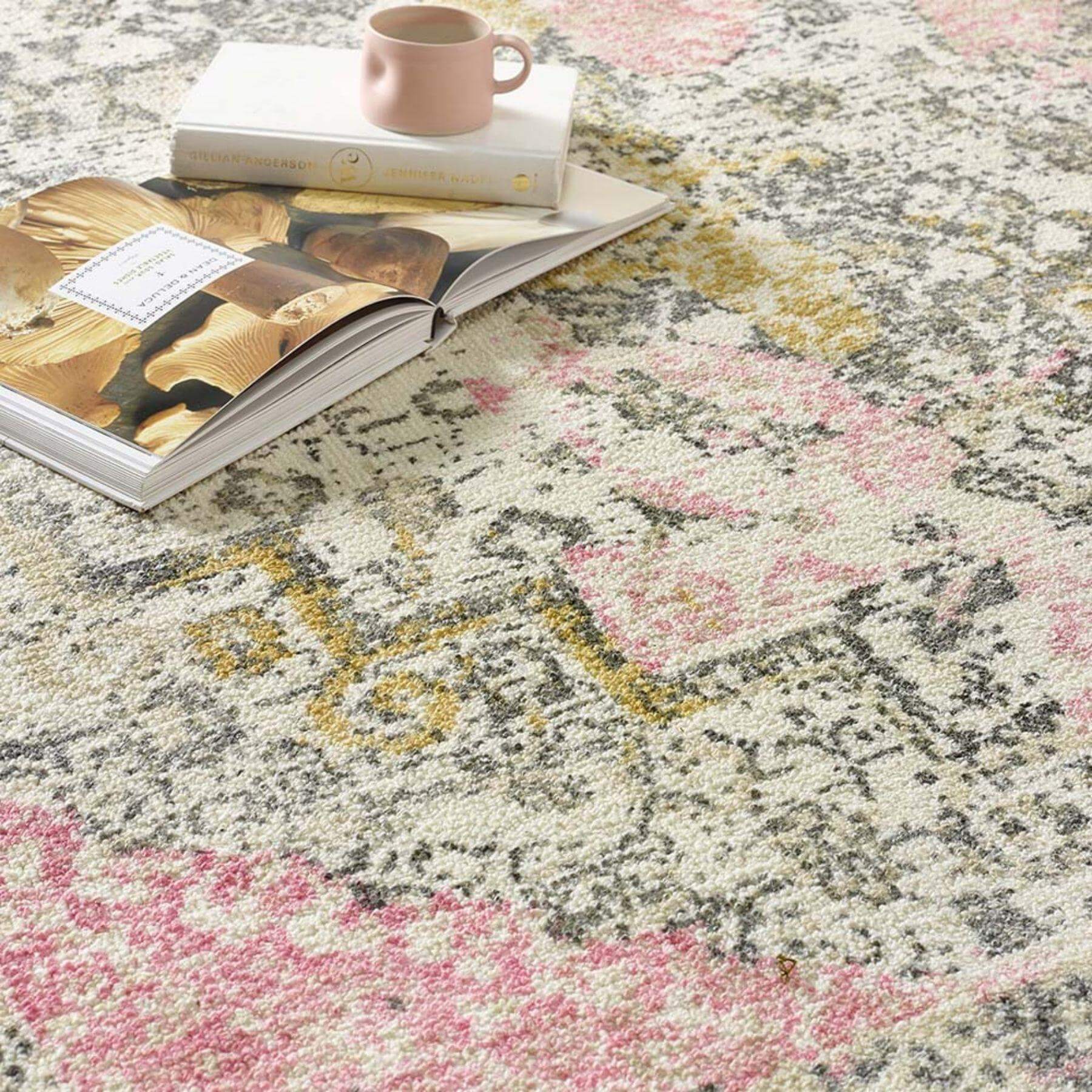 A plush vogue vintage pink rug with a soft cream base and intricate floral patterns in muted pink gray and gold tones