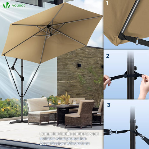 Beige fabric canopy of vounot cantilever garden parasol with black metal frame crank handle and wind protection straps