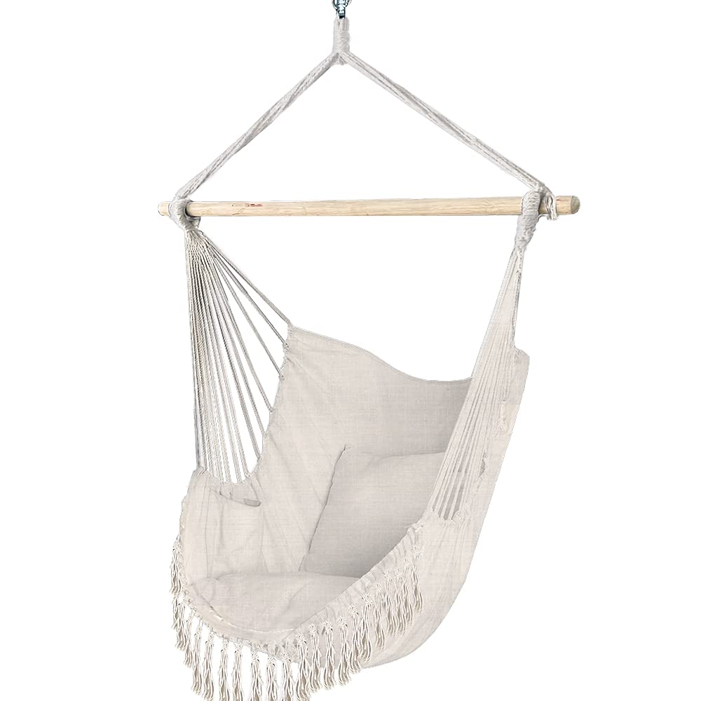 Cream-colored hanging chair with wooden bar and fringed rope detail macrame hammock swing chair with cushion