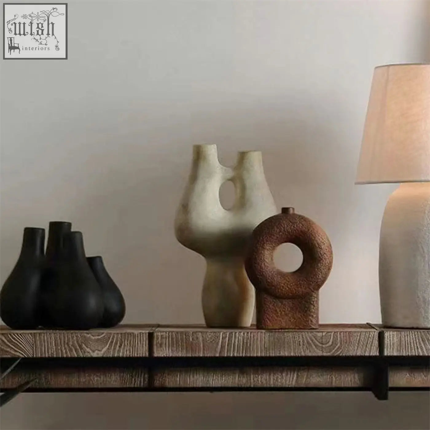 A rustic brown ceramic vase with a textured finish and circular hole in the center wabi ceramic vase
