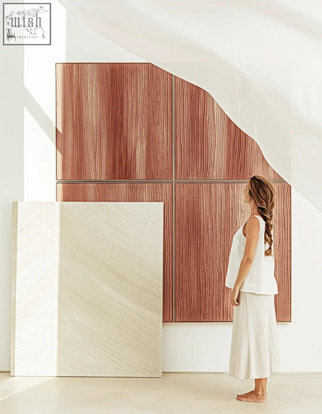 A woman stands beside walburga wall art background panels in warm wood grain and soft beige textures with low shipping cost