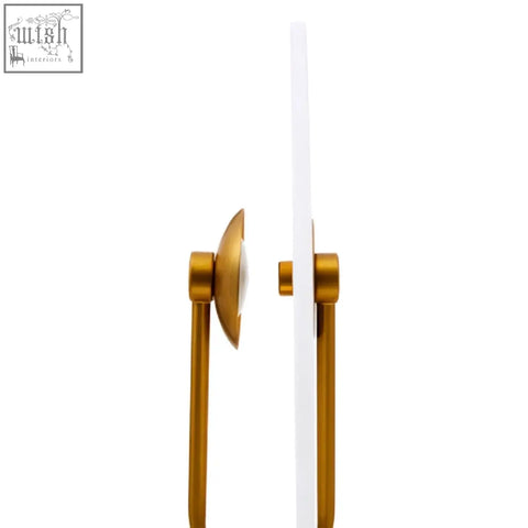 Gold-colored metal door handle with sleek circular pull plate on the waldorf marble table lamp base