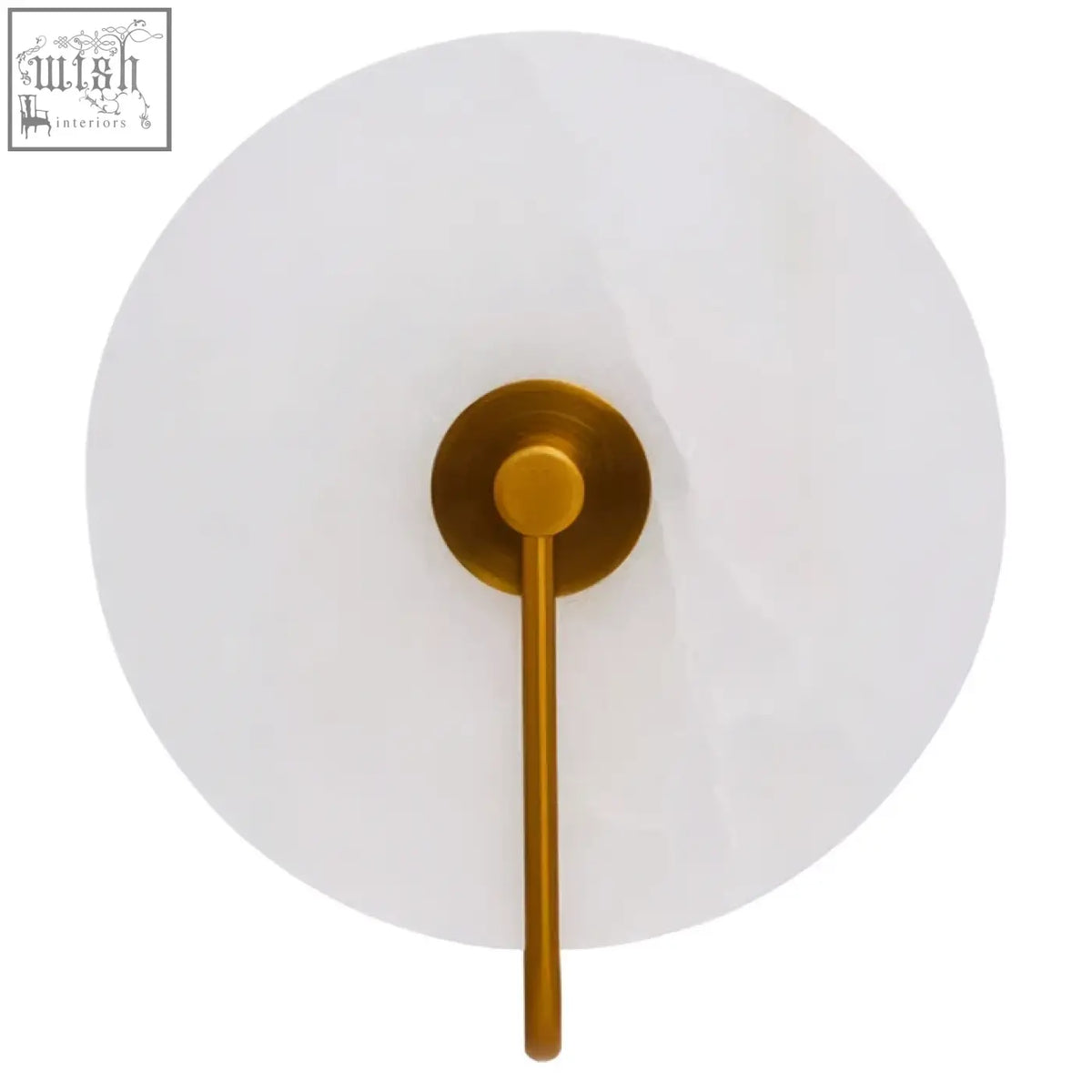 Gold-toned waldorf white marble wall light with circular frosted glass shade and slender stem on marble wall