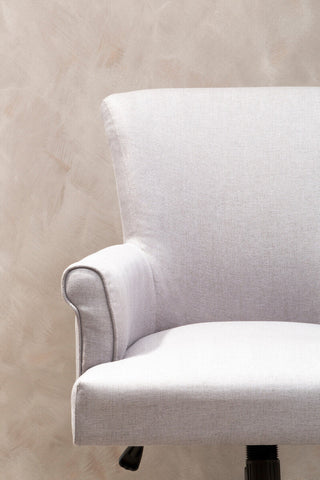 A sleek grey home office chair with off-white textured upholstery and clean modern lines for your workspace