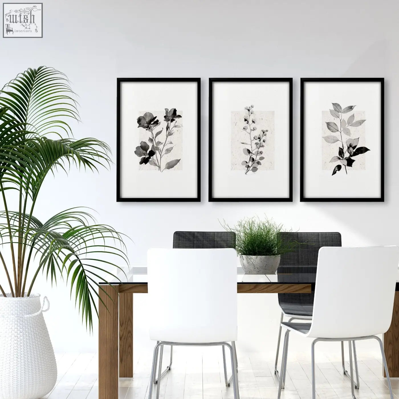 Three black-framed grey french country botanical floral wall art canvas prints hanging above a dining room table