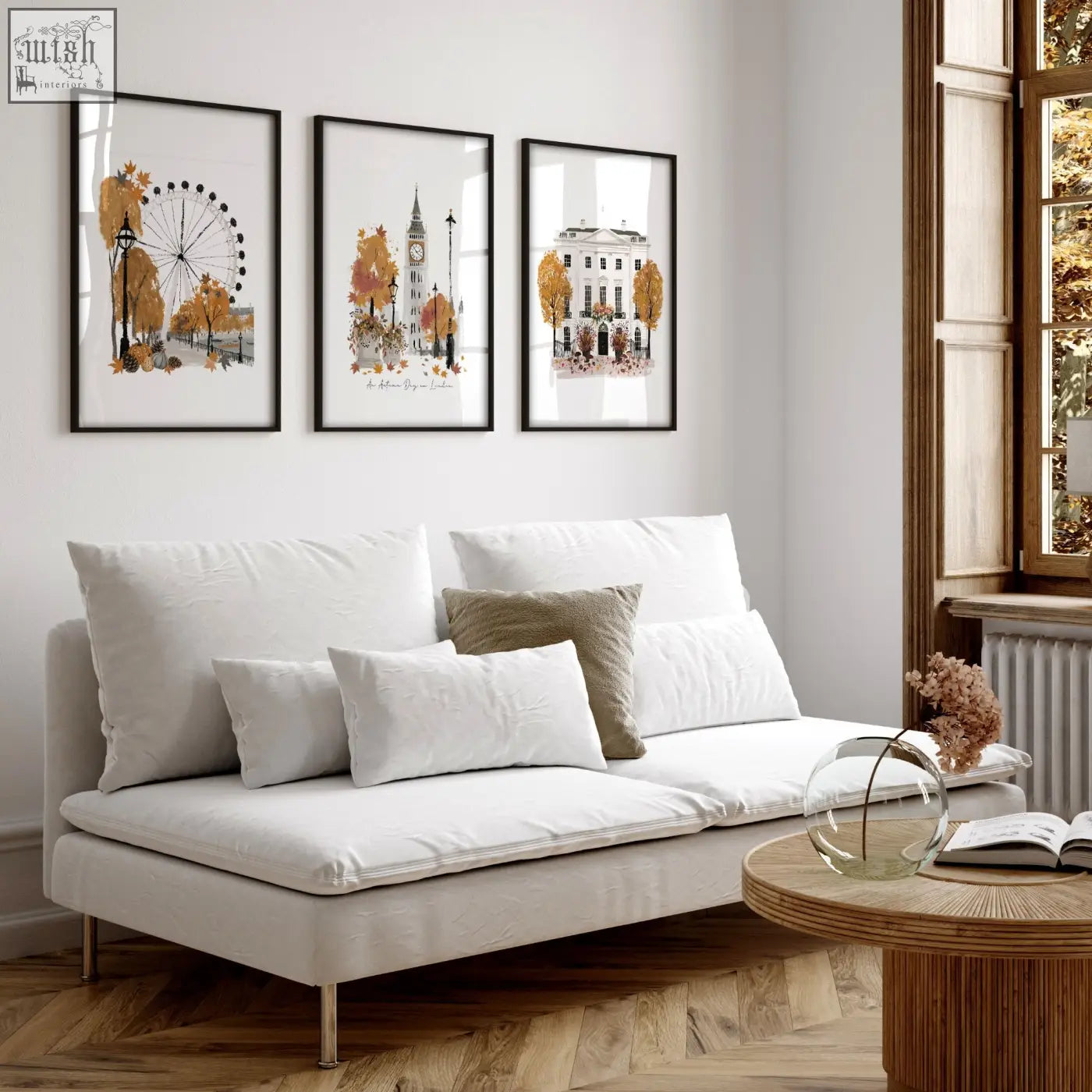 White upholstered sofa with metallic legs and cushions in living room featuring autumn day in london wall art decor prints