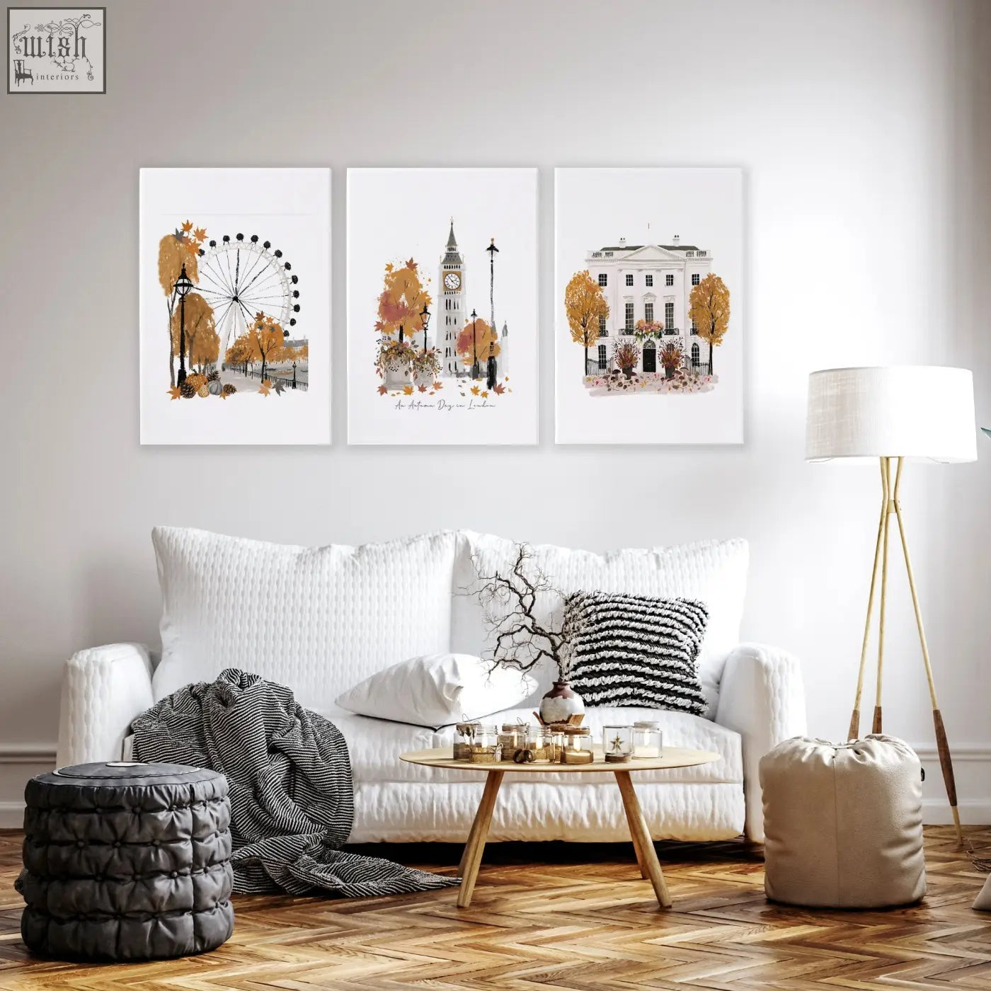 Three framed watercolor wall art decor prints of autumn london landmarks above a white living room sofa