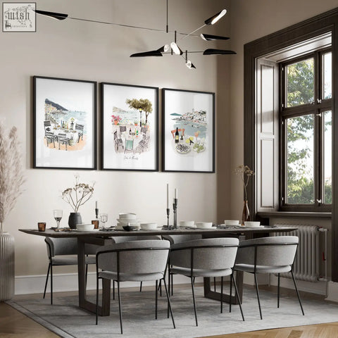 Modern dark wood dining table with sleek black metal legs in dining room featuring wall art three prints set