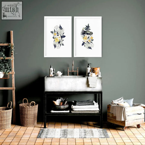 Concrete sink with copper faucet and black metal frame under floral wall art prints for bathroom walls set of 2