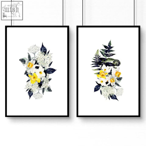 Two framed floral wall art prints with white and yellow flowers in black frames perfect for bathroom walls