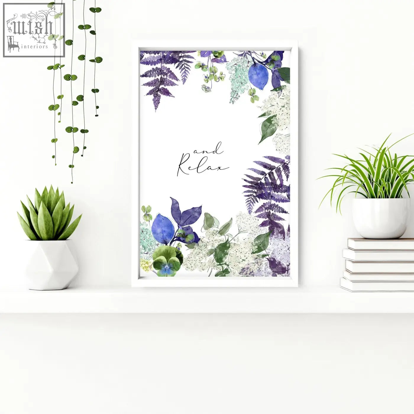 A framed watercolor wall art print with purple blue flowers green ferns and white blossoms saying and relax for bathrooms