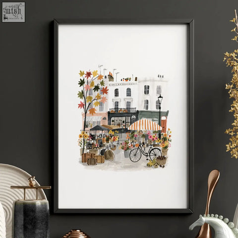 Black-framed watercolor wall art living room print of charming autumn street scene with vintage paris buildings