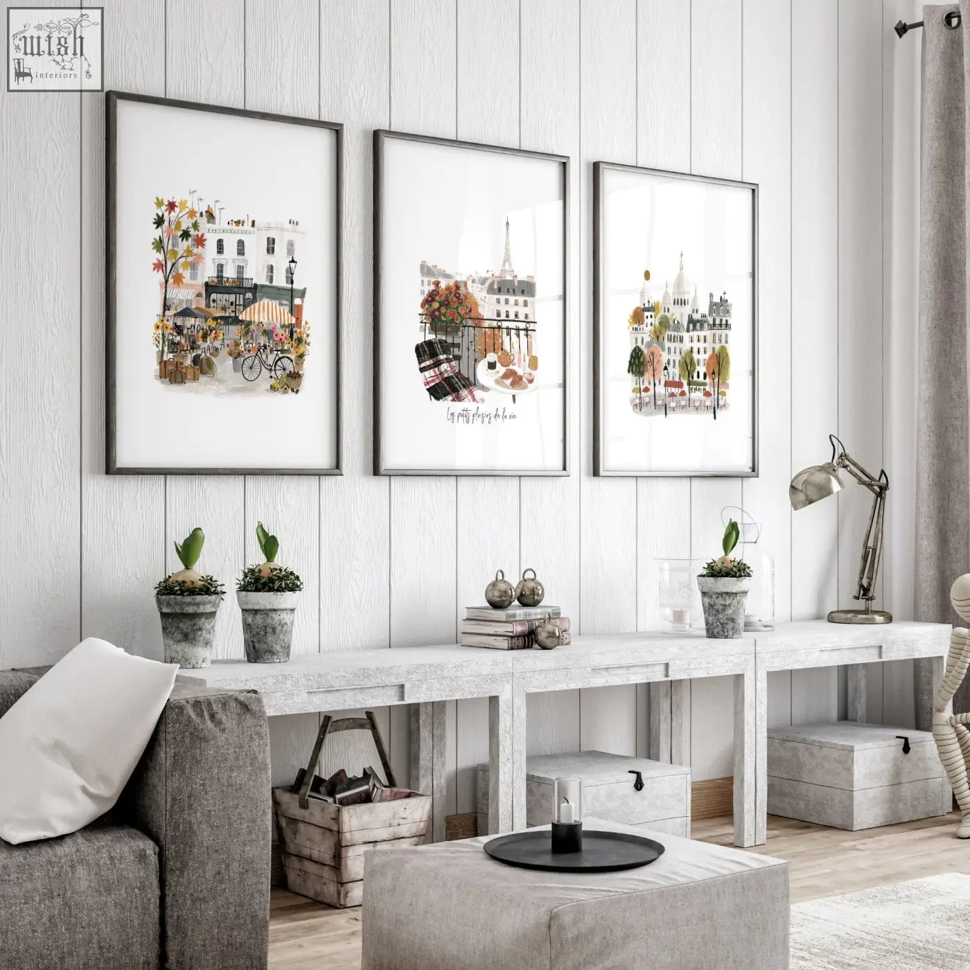 Three parisian-themed framed wall art prints with black frames hang on a white wooden wall for living room decor