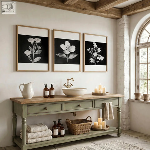 A set of three wall art nature charcoal botanical floral prints with black and white illustrations in light wood frames