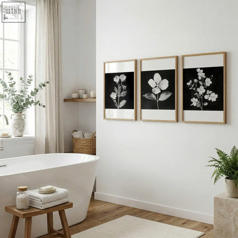 Three framed wall art nature prints with black and white charcoal floral designs in light wood frames