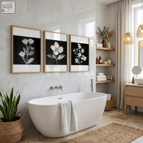 White freestanding bathtub with sleek modern design paired with wall art nature charcoal botanical floral prints set of 3