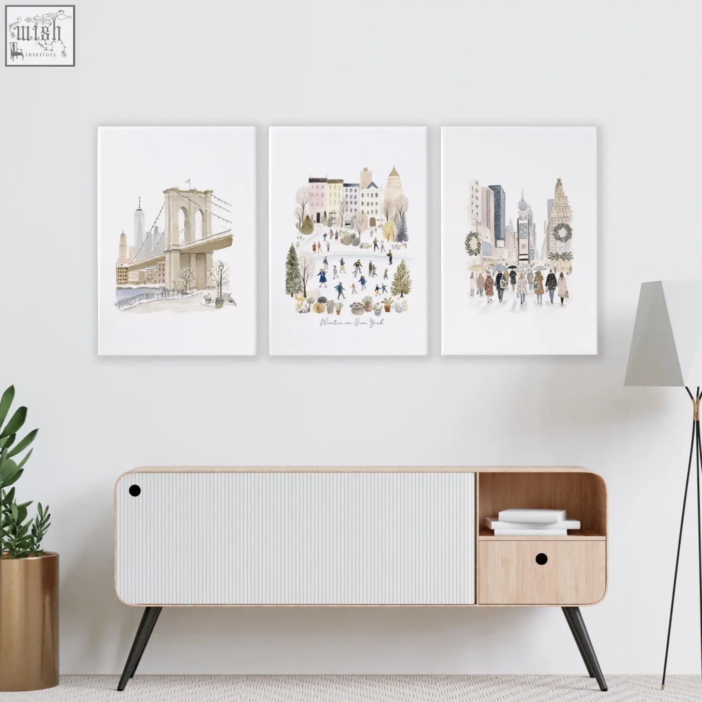 Three framed beige pastel nyc travel art prints hang above a modern wood sideboard as stylish living room wall decor ideas