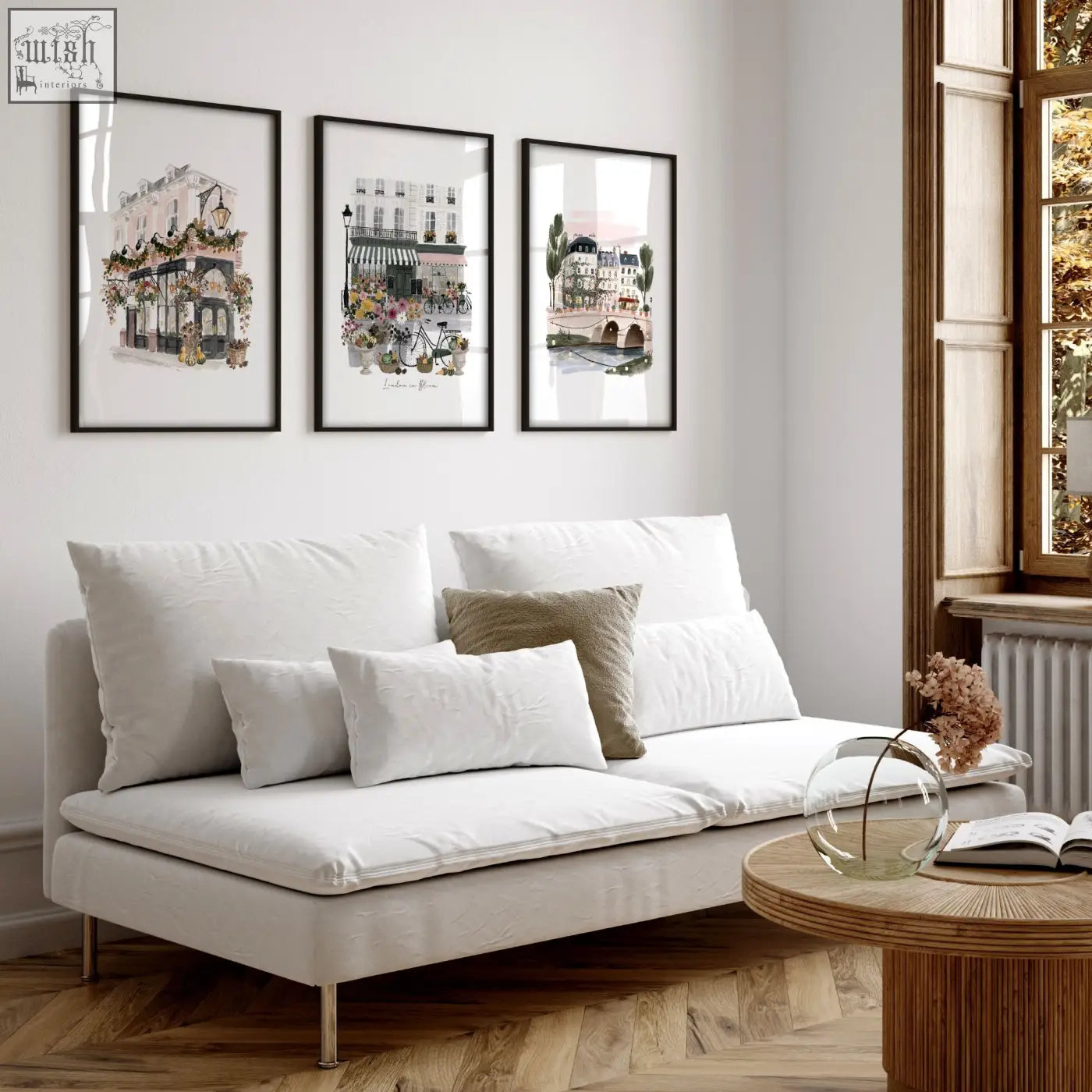 White upholstered sofa with metallic legs and cushions next to london in bloom british travel wall decoration living room set