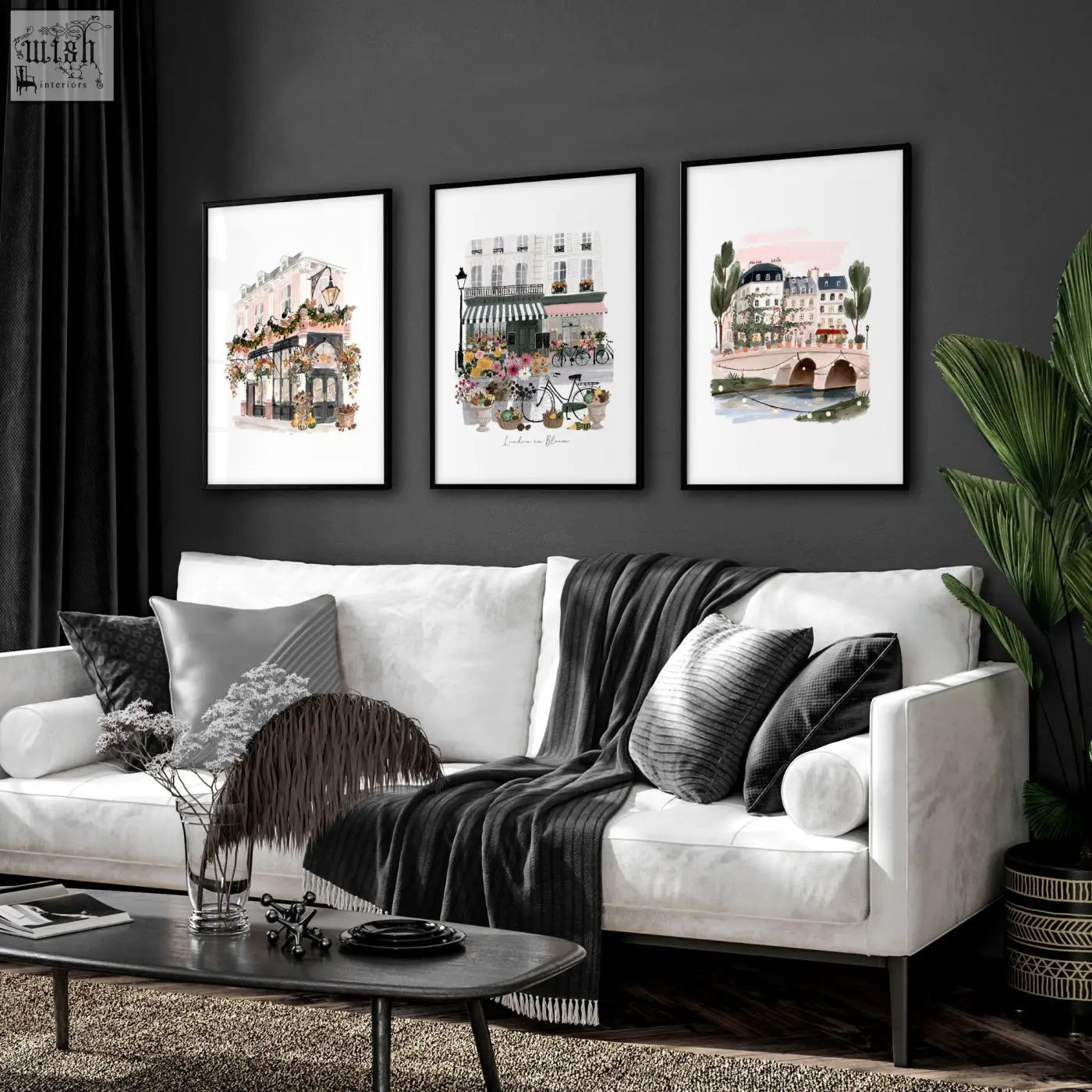 White sofa with black and gray pillows and dark gray blanket in living room featuring london in bloom wall decoration living set of 3