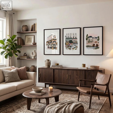 Three framed parisian illustrations hang above a dark wood sideboard as wall decoration living room art prints set