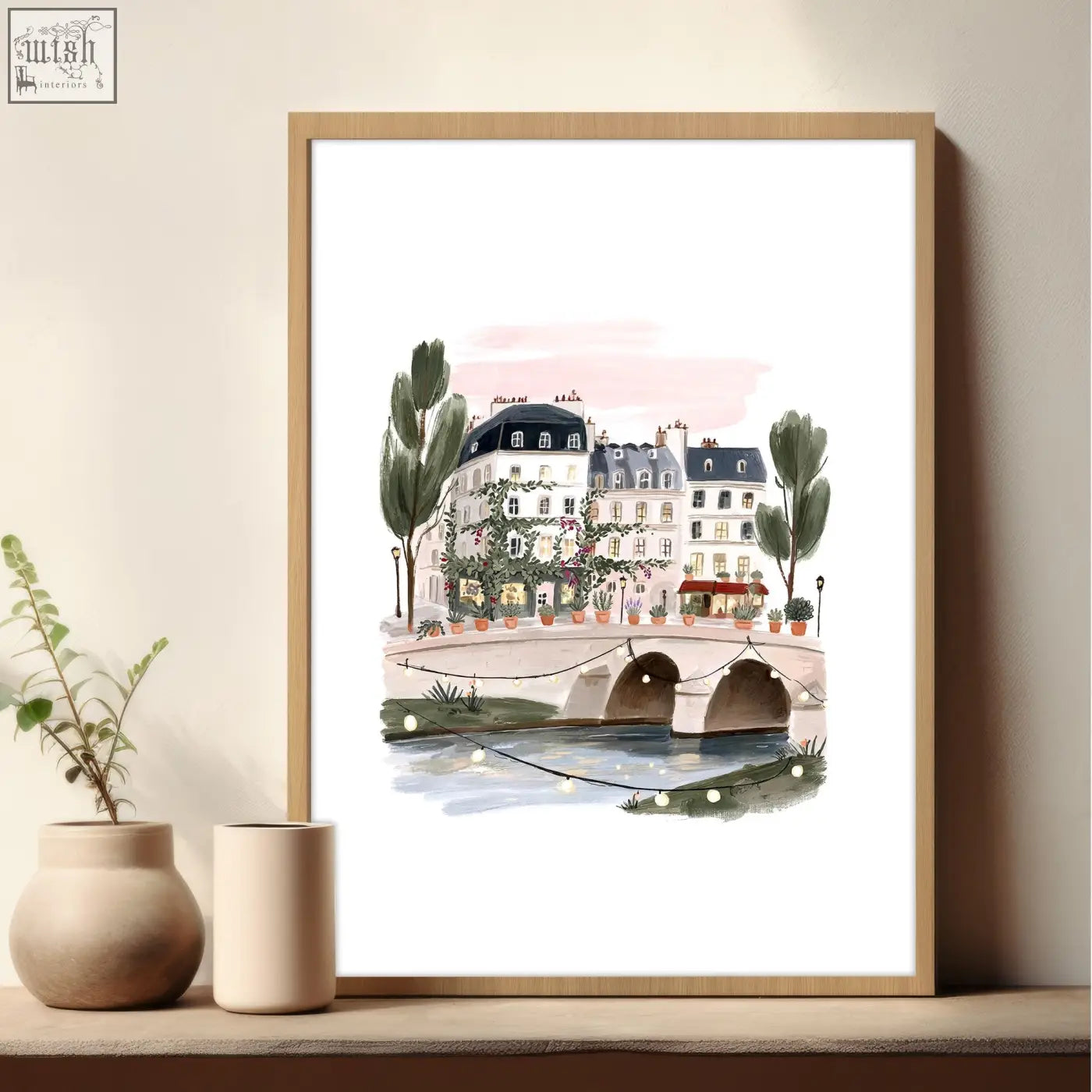 A framed watercolor parisian bridge illustration in pastel pink and green hues for living room wall decoration