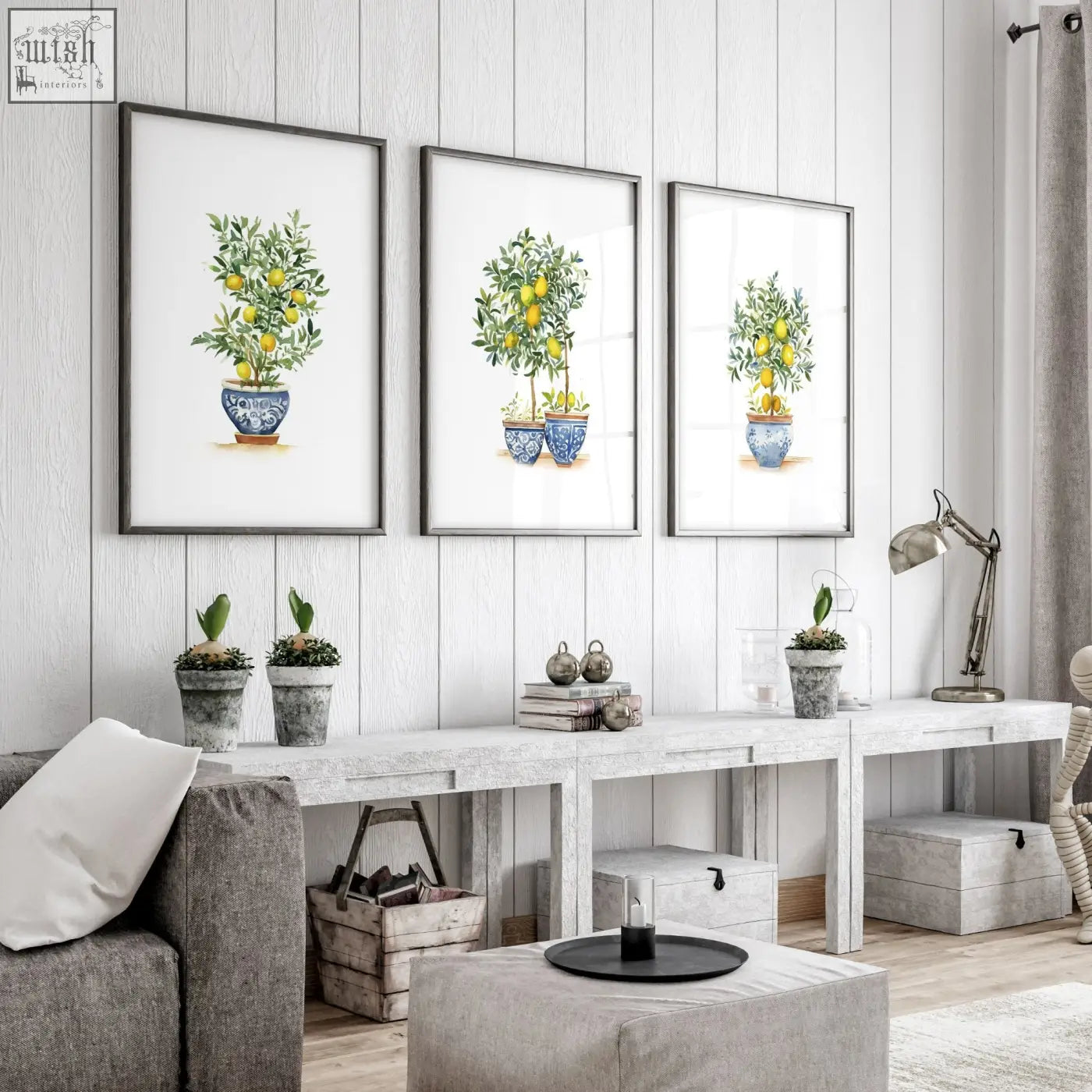 Three framed lemon tree art prints in blue and white ceramic pots on a light gray wall for living room decor