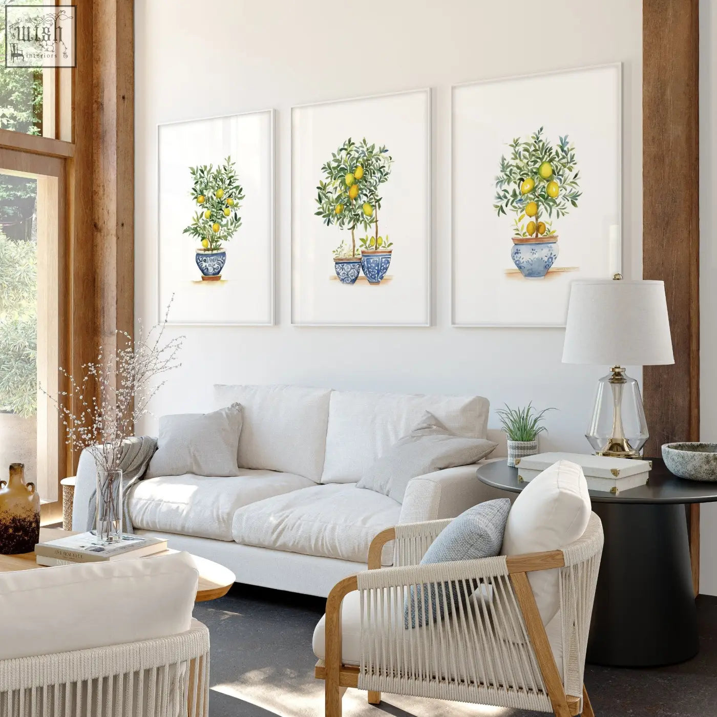 Three framed lemon tree art prints in blue and white ceramic pots hung symmetrically on a living room wall