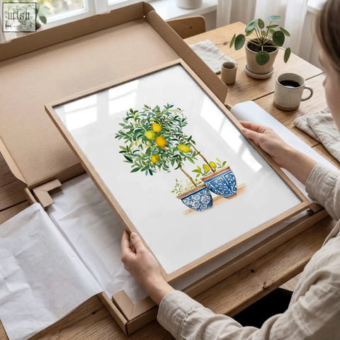 A framed lemon tree watercolor art print in blue and green tones with a light wood frame for living room wall decor