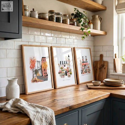 Three framed travel art prints with autumnal and urban scenes in light wood frames perfect as kitchen wall hangings