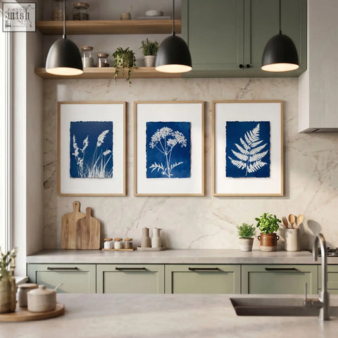 Three framed wall paintings of indigo cyanotype botanical prints in light wood frames perfect for a country cottage kitchen
