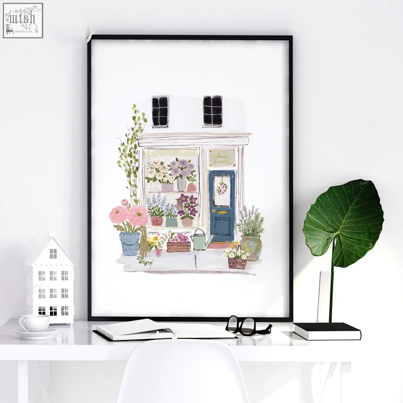 A framed watercolor flower shop wall print with pastel blooms and greenery perfect for dining room decor blue tones
