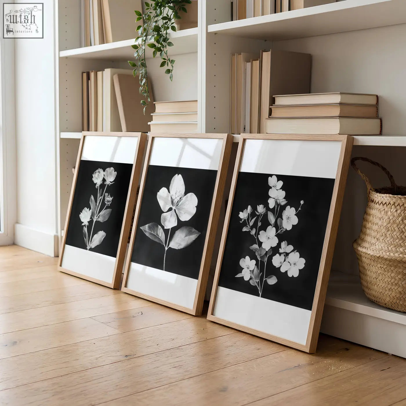 Three framed living room wall prints featuring black and white white botanical florals in light wood frames french country style