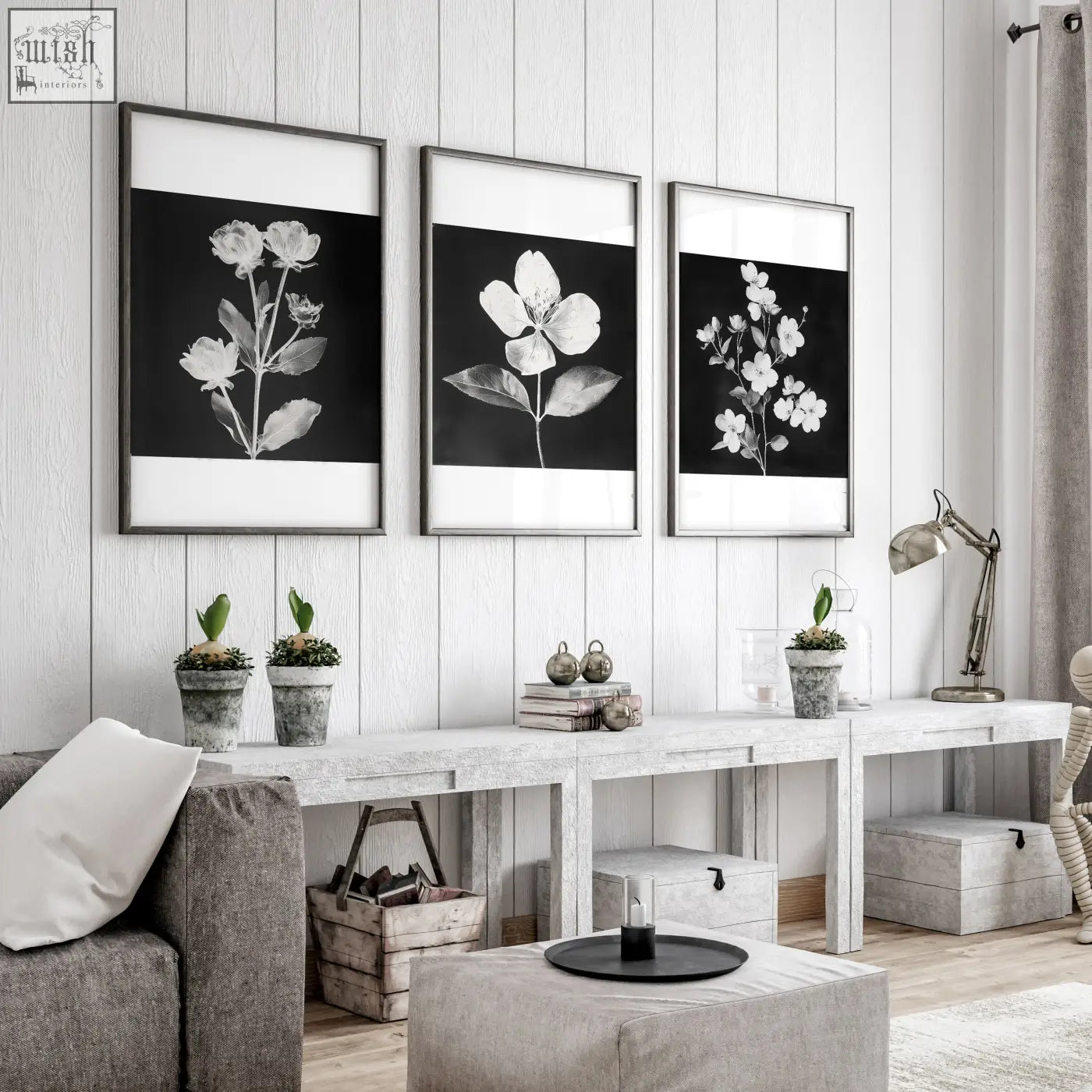 Three framed black and white botanical prints with thin metallic frames hanging on a white wooden wall for living room french country decor