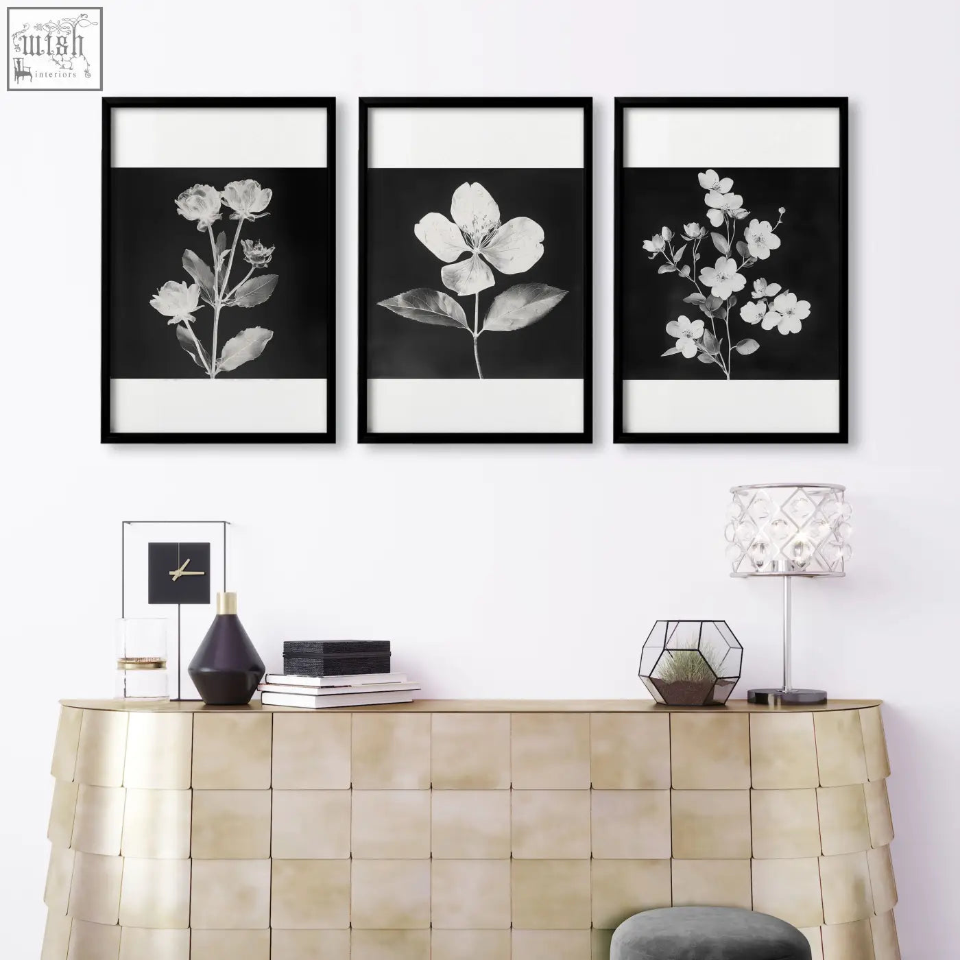 Three black and white botanical floral wall prints in sleek black frames above a gold console table for living room french country style