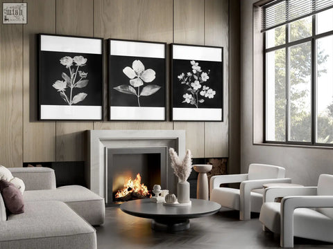 Three black frames with white botanical floral prints displayed above a fireplace for a french country living room