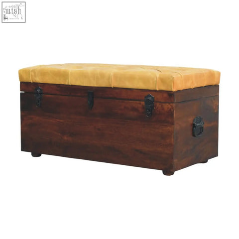 Rustic dark wood trunk bench with tufted mustard-yellow cushion and tan leather black metal latches
