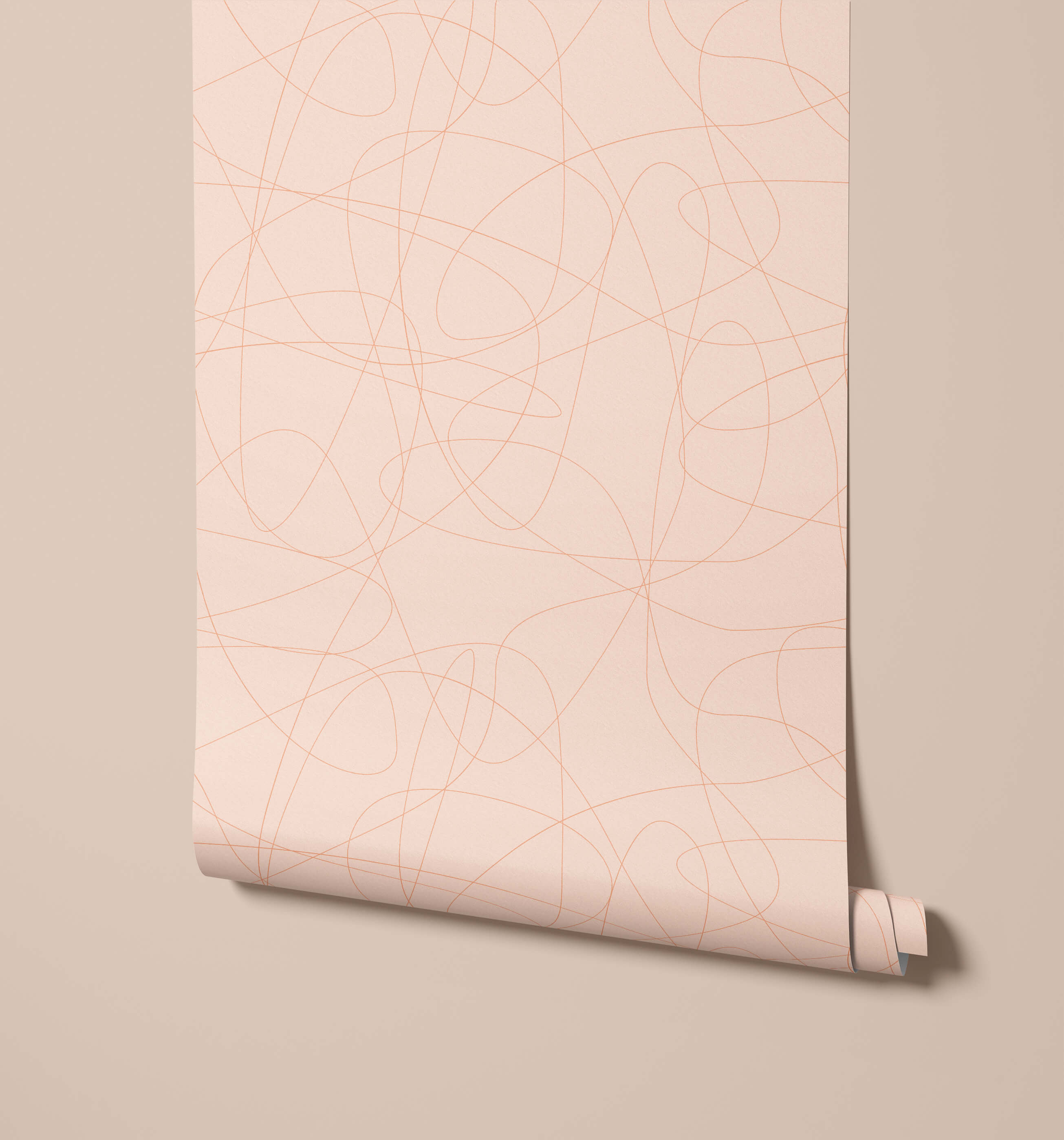 A soft blush pink wallpaper roll called wander with delicate intersecting gold-toned abstract lines