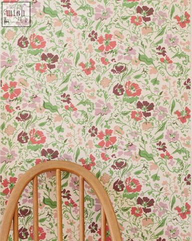 Wandle Wilde wallpaper fire features oversized floral pink red and green blossoms on an off-white background